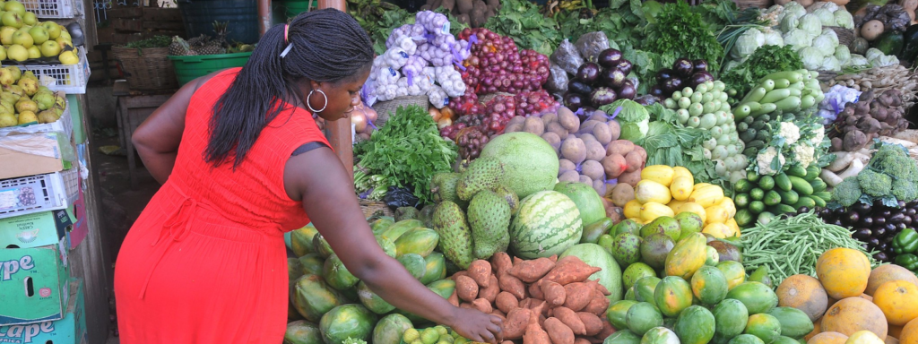 A woman inspects vegetables for sale in Accra, Ghana.